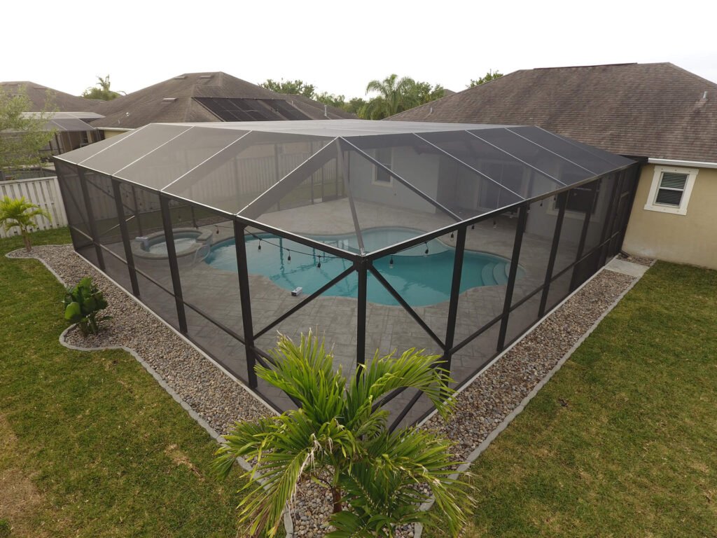 Pool screen enclosure installation in Panama City, FL covering residential backyard pool